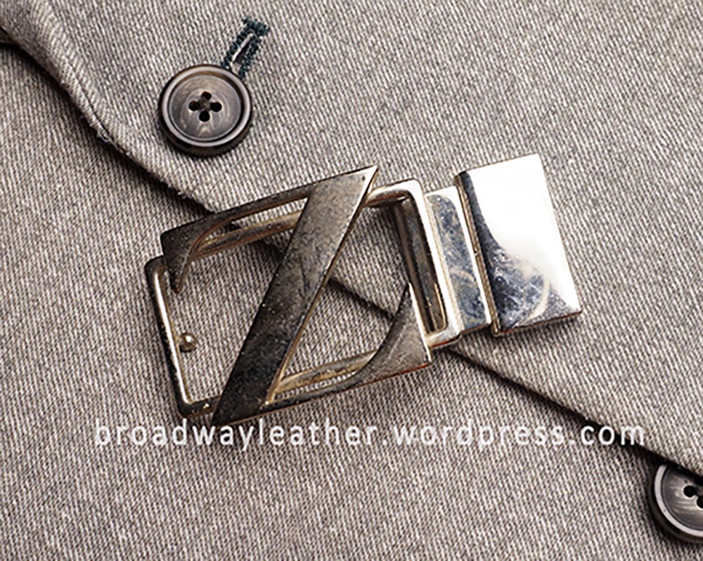 Worn out Zegna belt buckle with loss of shine, oxidation and grime build up.