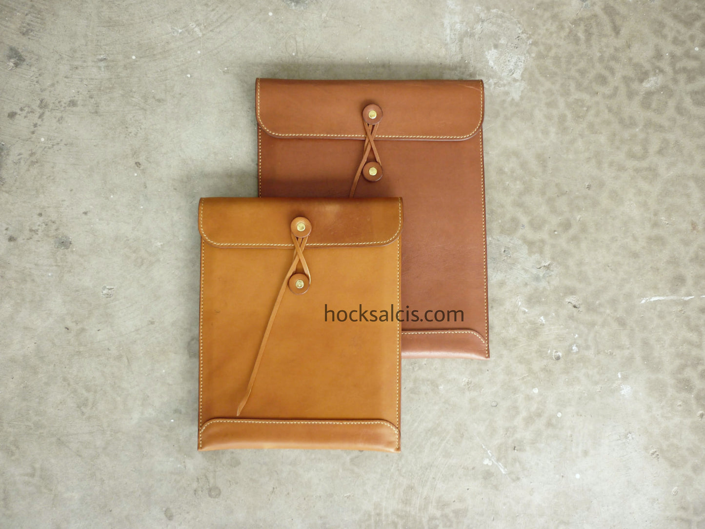 two leather laptop cases custom crafted in string tie envelope design