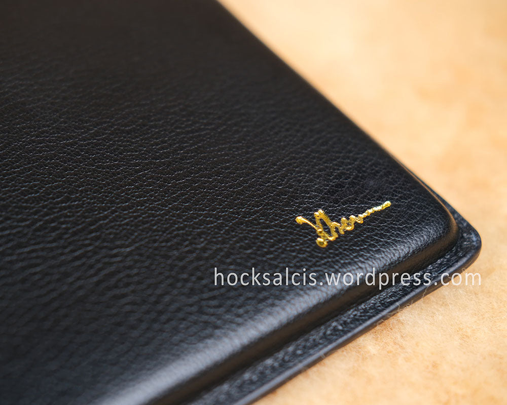 Gold foil printed name and initials on leather laptop sleeve