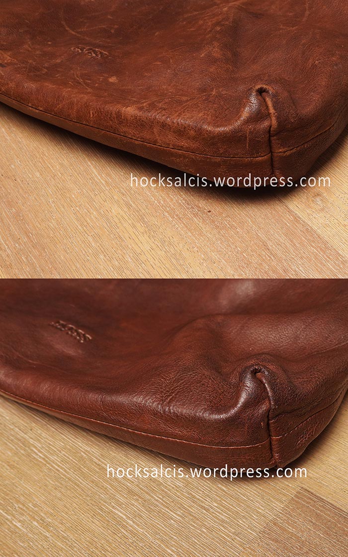 Damaged surface of Hugo Boss leather bag restored to pristine conditions.